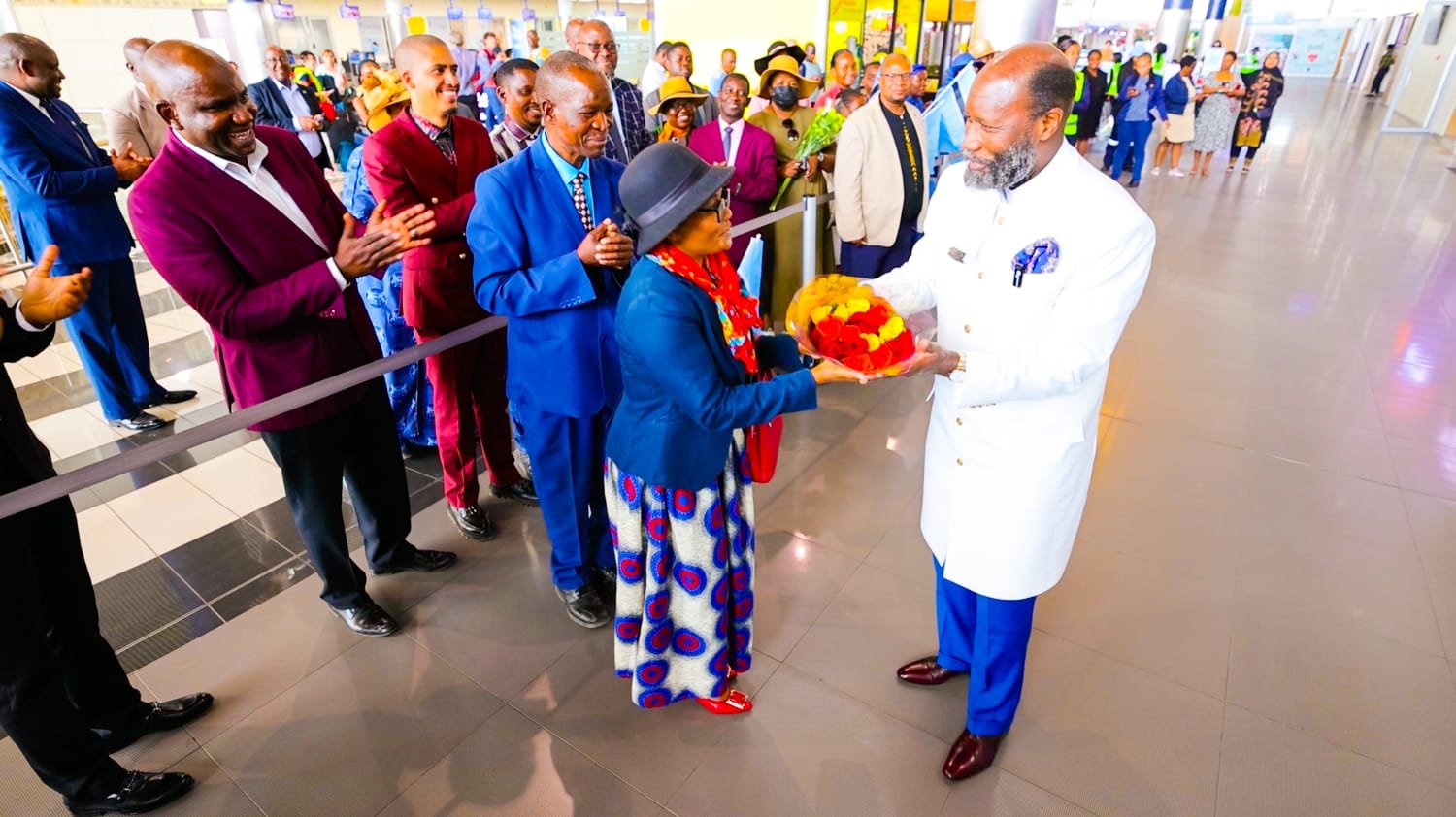 Prophet Dr. David Edward Owuor is presented with flowers on arrival in Gaborone, Botswana