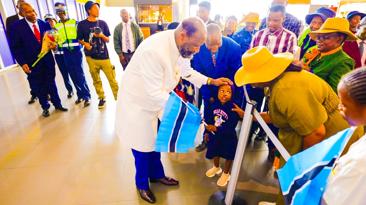 Prophet Dr. David Edward Owuor greets a young girl on arrival in Gaborone, Botswana