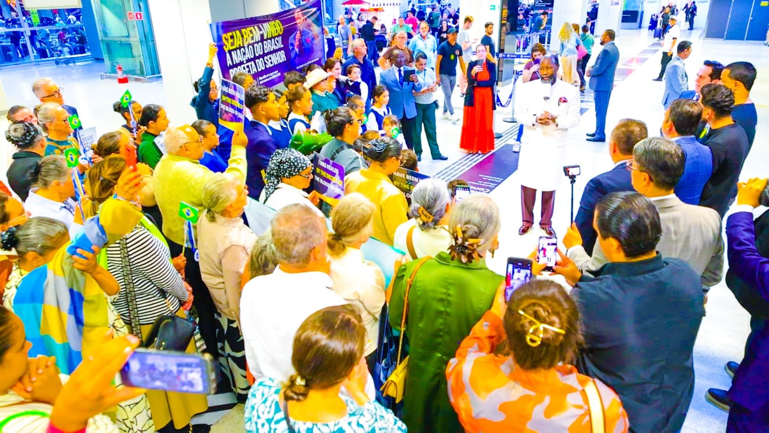 Crowds with Brazilian flags welcome Prophet Dr. David Owuor on his arrival in Brazil