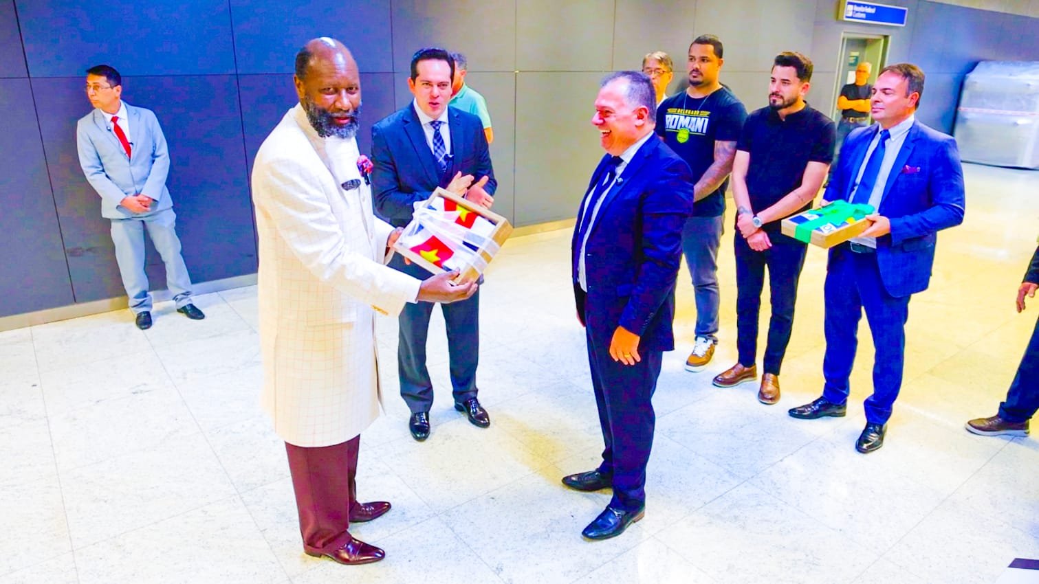Brazilian pastors and leaders present the national flag to Prophet Dr. David Owuor at São Paulo airport