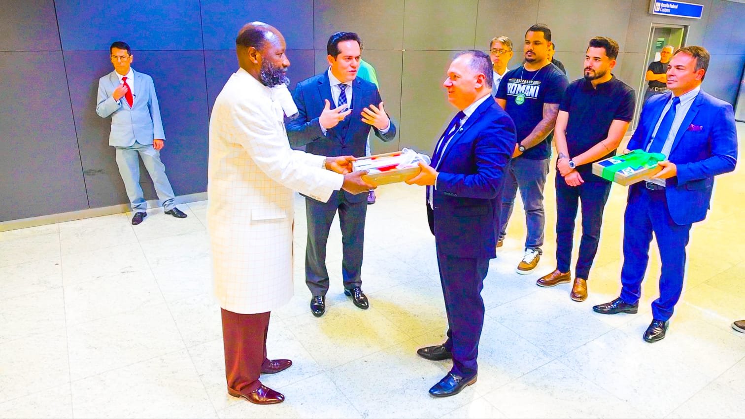 Prophet Dr. David Owuor is presented with the Brazilian flag by the President of Pastors on arrival in Brazil